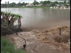 Two year old Indian kid standing calmly in the midst of flash floods