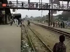 Guy surfing on train hit by overpass and tumbles infront of shocked bystanders