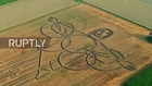 Italy: Land artist ploughs giant Olympics tribute with tractor