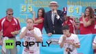 USA: See competitive eater chow down 62 hot dogs in 10 minutes
