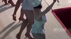 European girls in G-strings and mini skirts dance at shopping mall